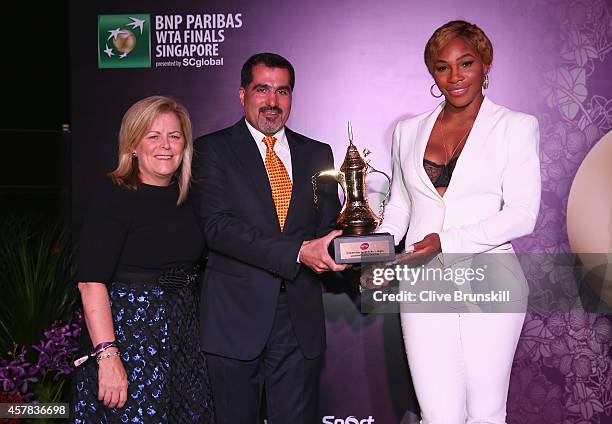 Serena Williams of the United States poses for a photograph with her WTA Year End World Number One Singles Trophy sponsored by Dubai Duty Free along...