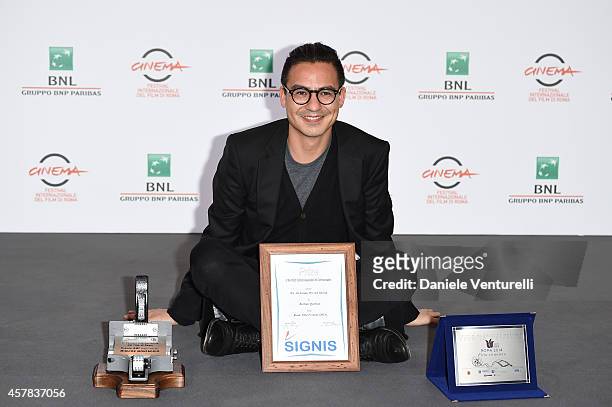 Burhan Qurbani is bestowed with the SIGNIS, AMC and "Sorriso diverso Roma 2014" Awards at the Collateral Awards Photocall during the 9th Rome Film...