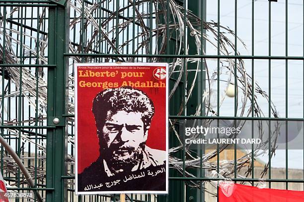 Poster reading "Freedom for Georges Abdallah" is placed near razor wire on the gate outside the prison in Lannemezan, southern France, on October 25...