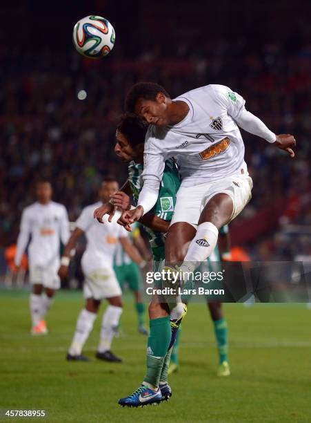 Adil Karrouchy of Casablanca goes up for a header with Jo of Mineiro during the FIFA Club World Cup Semi Final match between Raja Casablanca and...