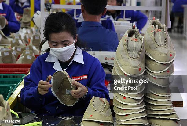 North Korean employees work at the assembly line of the factory of South Korean company at the Kaesong industrial complex on December 19, 2013 in...