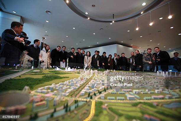 Officials from the G20 Seoul Conference look at miniature models of the Kaesong Industrial Complex on December 19, 2013 in Kaesong, North Korea....