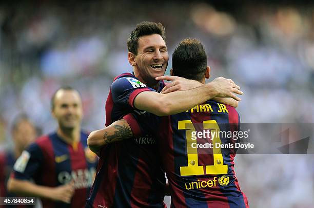Neymar of FC Barcelona celebrates with Lionel Messi after scoring his team's opening goal during the La Liga match between Real Madrid CF and FC...