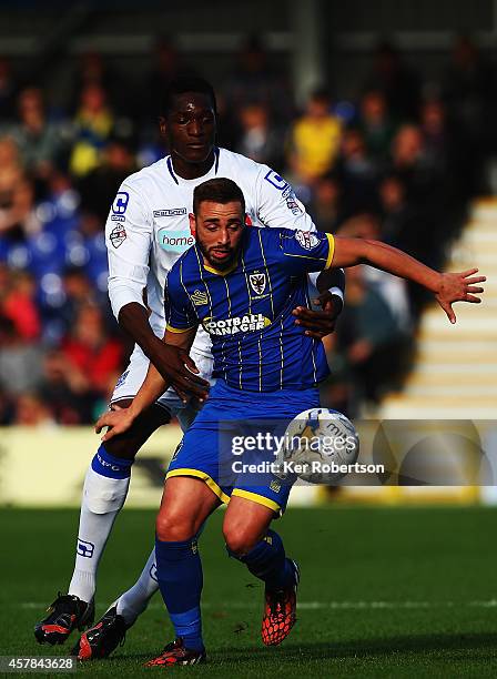 Sammy Moore of AFC Wimbledon holds off Armand Gnanduillet of Tranmere Rovers during the Sky Bet League Two match between AFC Wimbledon and Tranmere...