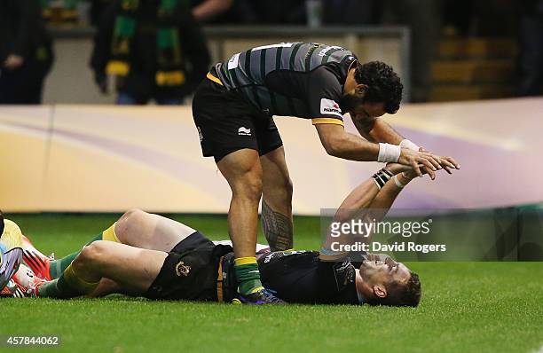 George North of Northampton celebrates with team mate Kahn Fotuali'i after scoring his fourth try of the match during the European Rugby Champions...