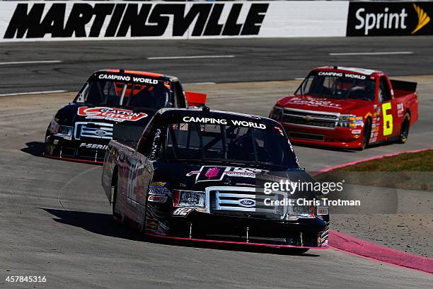 Cody Erickson, driver of the Performance Auto Ford, leads Cole Custer, driver of the Haas Automation Chevrolet, and Norm Benning, driver of the Tom...