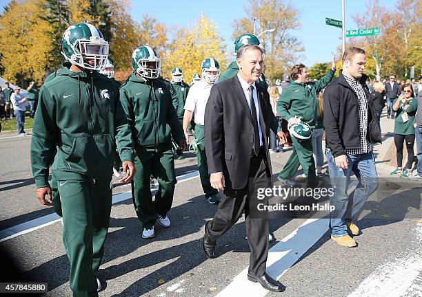 Michigan State Spartans head football coach Mark Dantonio walks with his team to Spartan Stadium on October 25 , 2014 in East Lansing, Michigan.