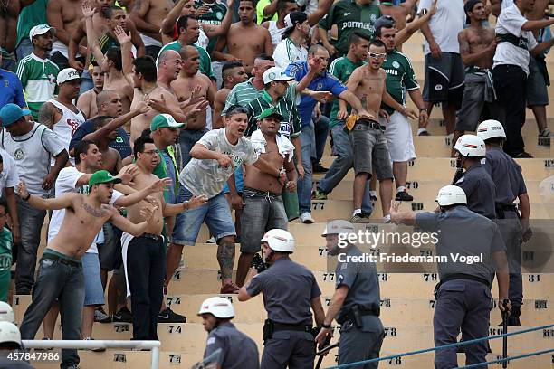 Fans of Palmeiras fights with the police during the match between Palmeiras and Corinthians for the Brazilian Series A 2014 at Estadio do Pacaembu on...