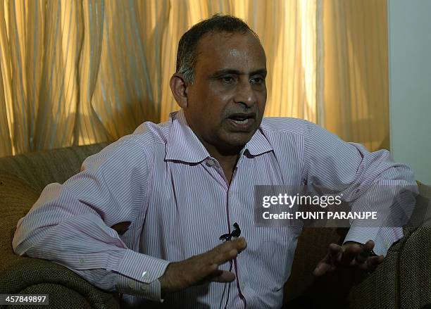 Uttam Khobragade, the father of Indian diplomat Devyani Khobragade gestures as he addresses media representatives during a news conference in Mumbai...