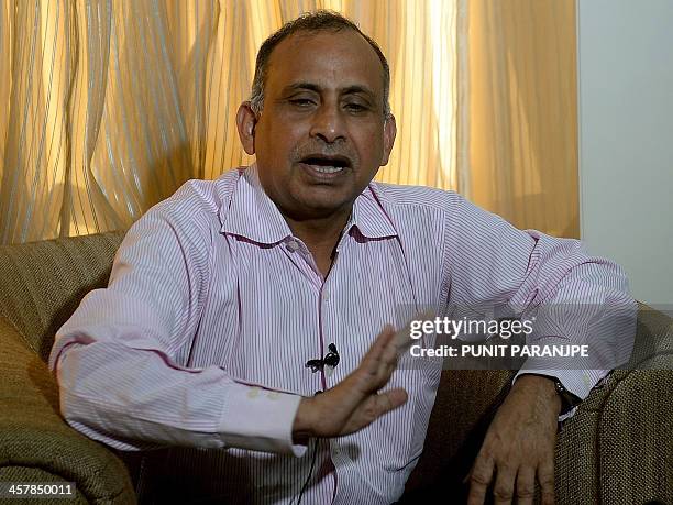 Uttam Khobragade, the father of Indian diplomat Devyani Khobragade gestures as he addresses media representatives during a news conference in Mumbai...