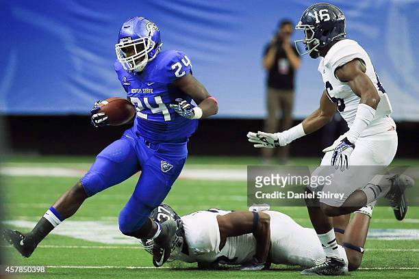 Marcus Caffey of the Georgia State Panthers runs the ball past Antwione Williams and Antonio Glover of the Georgia Southern Eagles in the first half...