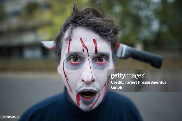 Zombie enthusiast walks over the Alexanderplatz as part of a flashmob on October 25, 2014 in Berlin, Germany. Over 150 participants dressed as...