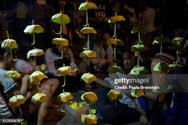 Hand made umbrellas are seen hanging at the main protest site as a festival atmosphere prevails October 25, 2014 in Hong Kong, Hong Kong. Sunday will...