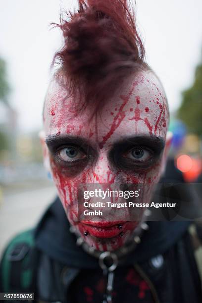 Zombie enthusiast walks over the Alexanderplatz as part of a flashmob on October 25, 2014 in Berlin, Germany. Over 150 participants dressed as...