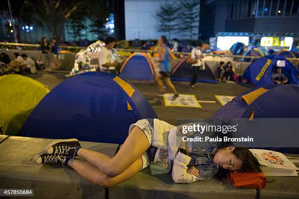 Woman sleeps amongst tents along the main protest campsite as a festival atmosphere prevails October 25, 2014 in Hong Kong, Hong Kong. Sunday will...