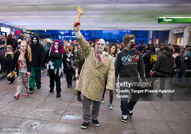 Zombie enthusiasts walk over the Alexanderplatz as part of a flashmob on October 25, 2014 in Berlin, Germany. Over 150 participants dressed as...