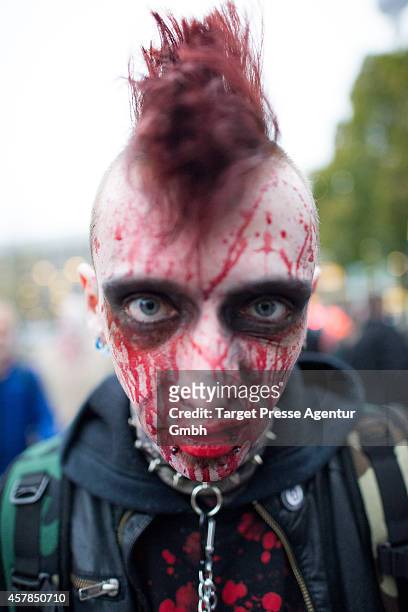 Zombie enthusiast walks over the Alexanderplatz as part of a flashmob on October 25, 2014 in Berlin, Germany. Over 150 participants dressed as...
