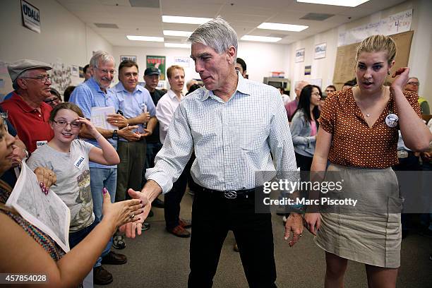 Senator Mark Udall shakes hands with volunteers at a canvass kickoff campaign on October 25, 2014 in Thornton, Colorado. Udall is seeking re-election...