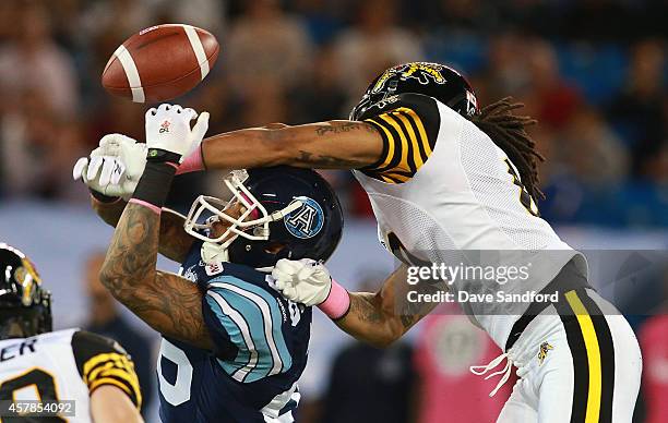 Rico Murray of the Hamilton Tiger-Cats causes pass interference on Maurice Mann of the Toronto Argonauts during their game at Rogers Centre on...