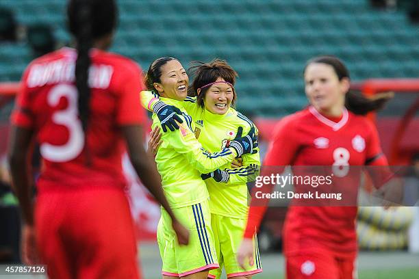 Yuki Ogimi of Japan celebrates scoring her team's first goal with her teammate Mizuho Sakaguchi during a match at Commonwealth Stadium on October 25,...