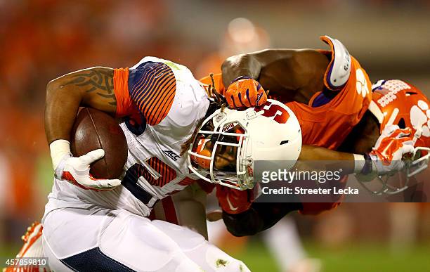 Prince-Tyson Gulley of the Syracuse Orange is tackled by Tony Steward of the Clemson Tigers during their game at Memorial Stadium on October 25, 2014...