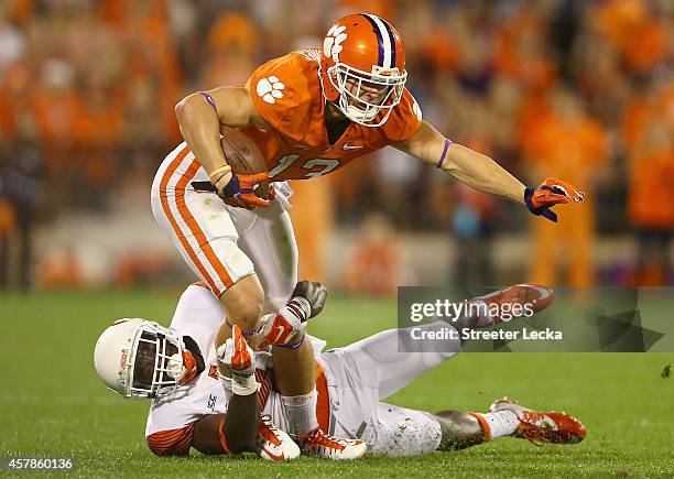 Brandon Reddish of the Syracuse Orange tackles Adam Humphries of the Clemson Tigers during their game at Memorial Stadium on October 25, 2014 in...