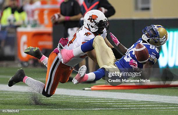 LaRose of the BC Lions knocks down intended receiver Justin Wilson of the Winnipeg Blue Bombers in first half action in a CFL game at Investors Group...
