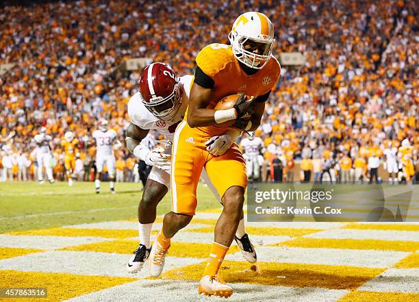Josh Malone of the Tennessee Volunteers pulls in this touchdown reception against Tony Brown of the Alabama Crimson Tide at Neyland Stadium on...