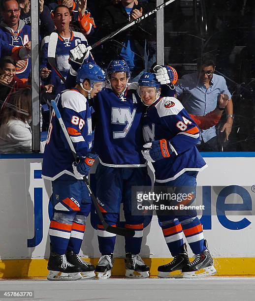 Frans Nielsen of the New York Islanders scores his second goal of the game at 15:09 of the third period against the Dallas Stars and is joined by...