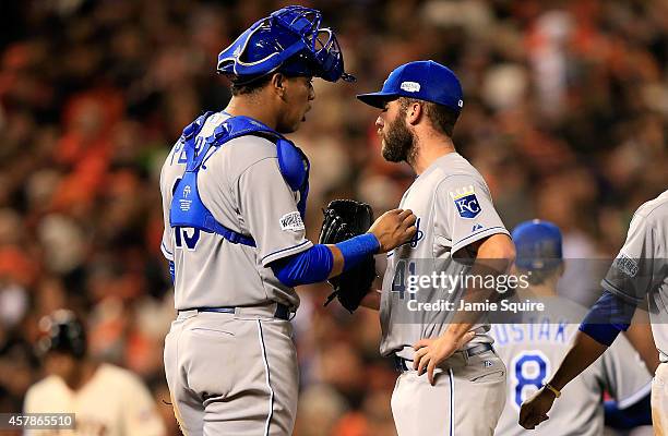 Salvador Perez talks with Danny Duffy of the Kansas City Royals in the fifth inning against the San Francisco Giants during Game Four of the 2014...