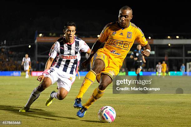 Joffre Guerron of Tigres drives the ball as Severo Meza of Monterrey follows him during a match between Monterrey and Tigres UANL as part of 14th...