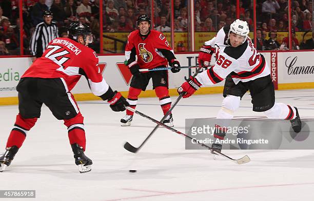 Jaromir Jagr of the New Jersey Devils scores the overtime winning goal on this wristshot that gets by Mark Borowiecki of the Ottawa Senators at...