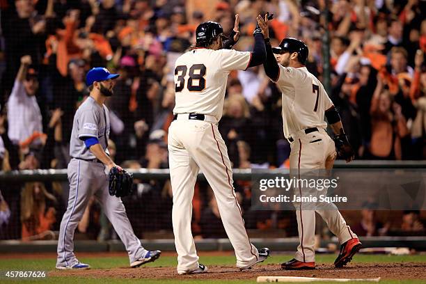 Gregor Blanco and Michael Morse of the San Francisco Giants celebrate after scoring on a two-run double by Joe Panik in the seventh inning against...