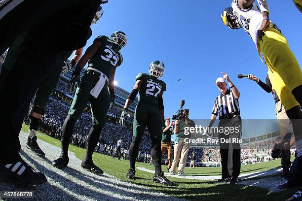 Kurtis Drummond and Jeremy Langford of the Michigan State Spartans during the coin toss against the Michigan Wolverines at Spartan Stadium on October...