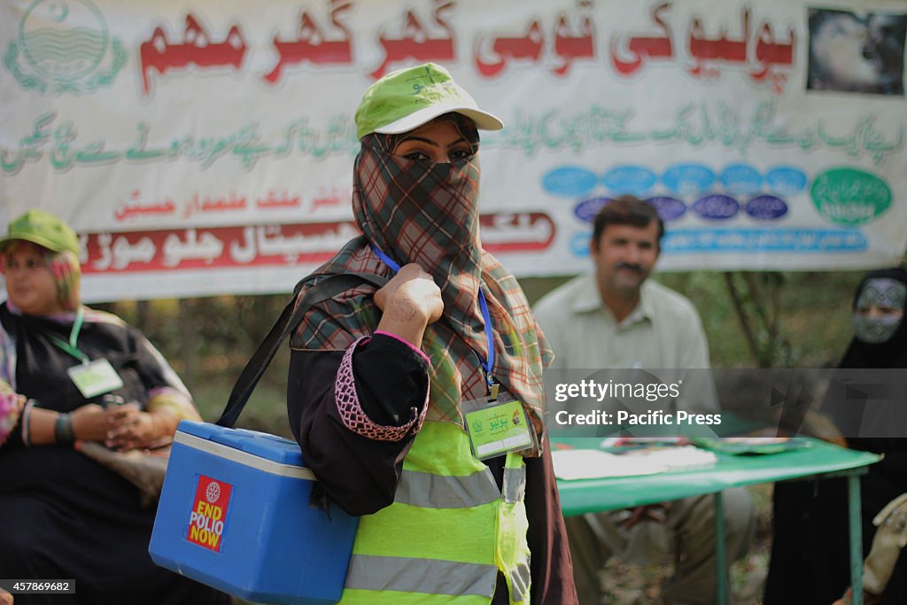 Pakistani Polio Vaccination Team administering polio drops...