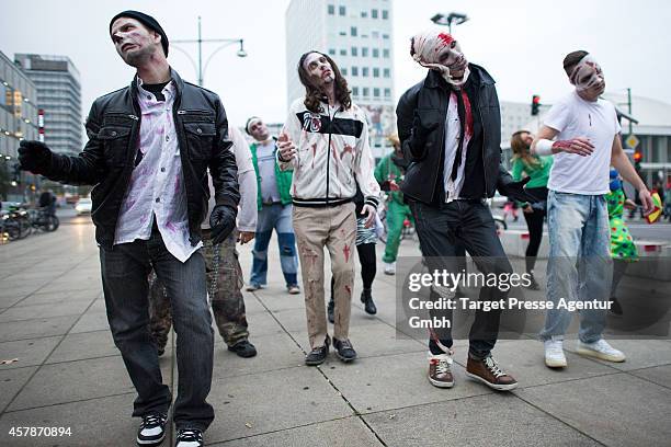 Zombie enthusiasts walk over the Alexanderplatz as part of a flashmob on October 25, 2014 in Berlin, Germany. Over 150 participants dressed as...