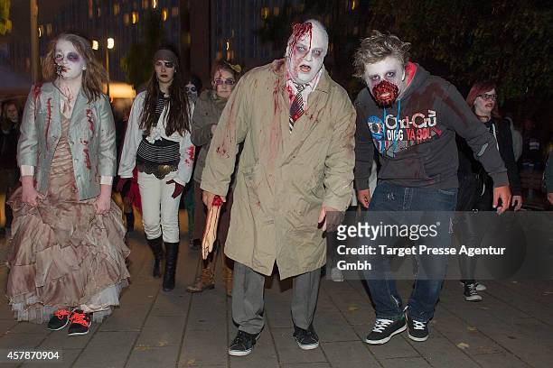 Zombie enthusiasts walk over the Alexanderplatz as part of a flashmob on October 25, 2014 in Berlin, Germany. Over 150 participants dressed as...