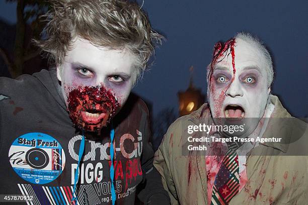 Zombie enthusiasts walk over the Alexanderplatz as part of a flashmob on October 25, 2014 in Berlin, Germany. Over 150 participants dressed as...