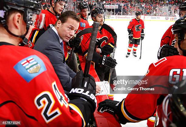 Assistant Coach Martin Gelinas of the Calgary Flames talks to his players during a game against the Washington Capitals at Scotiabank Saddledome on...