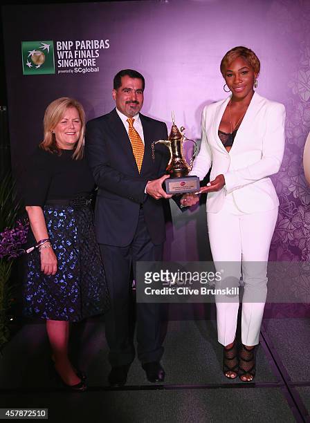 Serena Williams of the United States poses for a photograph with her WTA Year End World Number One Singles Trophy sponsored by Dubai Duty Free along...