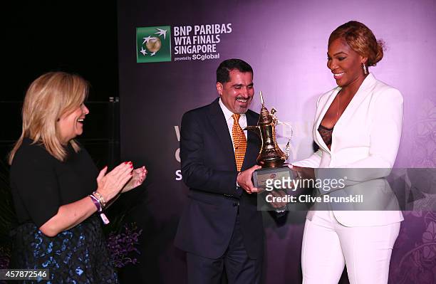 Serena Williams of the United States is presented with her WTA Year End World Number One Singles Trophy sponsored by Dubai Duty Free along with...