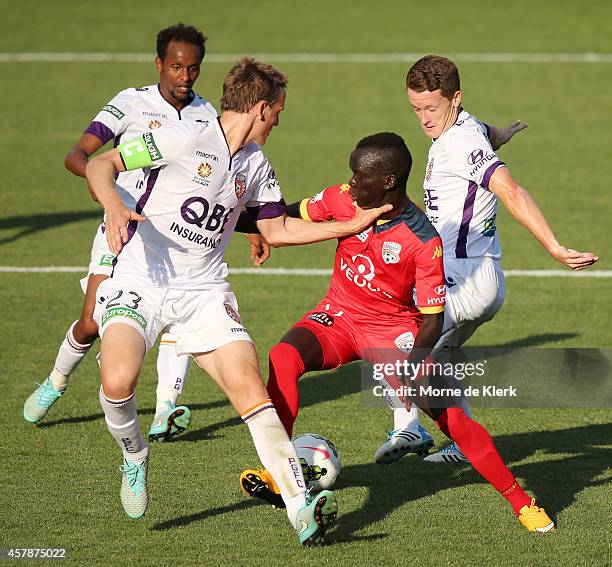 Awer Mabil of Adelaide United is tackled by Michael Thwaite of Perth Glory during the round three A-League match between Adelaide United and the...