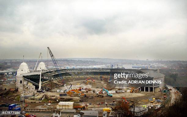 Heavy machinery continues the demolition work at Wembley Stadium in London 06 December 2002. Work begun today to dismantle the twin towers as one of...