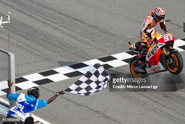 Marc Marquez of Spain and Repsol Honda Team crosses the finish line and wins the MotoGP Of Malaysia at Sepang Circuit on October 26, 2014 in Kuala...