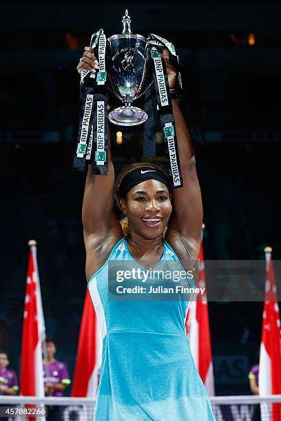 Serena Williams of USA celebrates with the Billie Jean King trophy after she defeats Simona Halep of Romania in the final during day seven of the BNP...