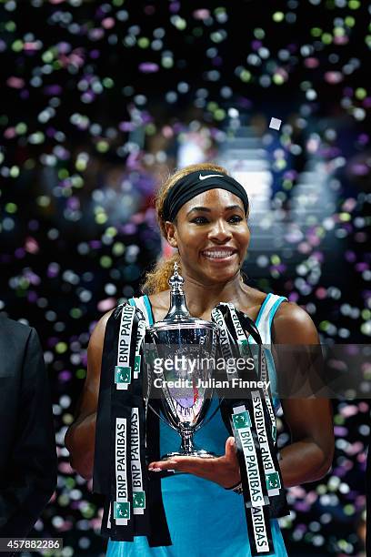 Serena Williams of USA celebrates with the Billie Jean King trophy after she defeats Simona Halep of Romania in the final during day seven of the BNP...