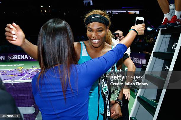 Friend congratulates Serena Williams of USA after she defeats Simona Halep of Romania in the final during day seven of the BNP Paribas WTA Finals...