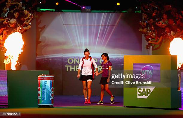 Simona Halep of Romania walks out for her match against Serena Williams of the United States in the final during the BNP Paribas WTA Finals at...
