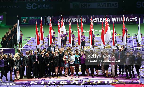 Serena Williams of the United States holds the Billie Jean King Trophy as she poses for a photograph with all the WTA staff after her straight sets...