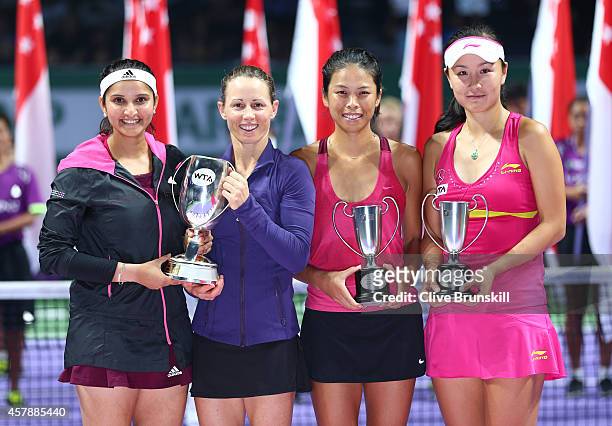 Cara Black of Zimbabwe and Sania Mirza of India pose for a photograph with Martina Navratilova and the Martina Navratilova Trophy after their...
